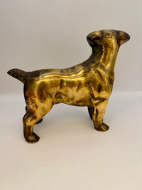Brass dog figurine on a white background