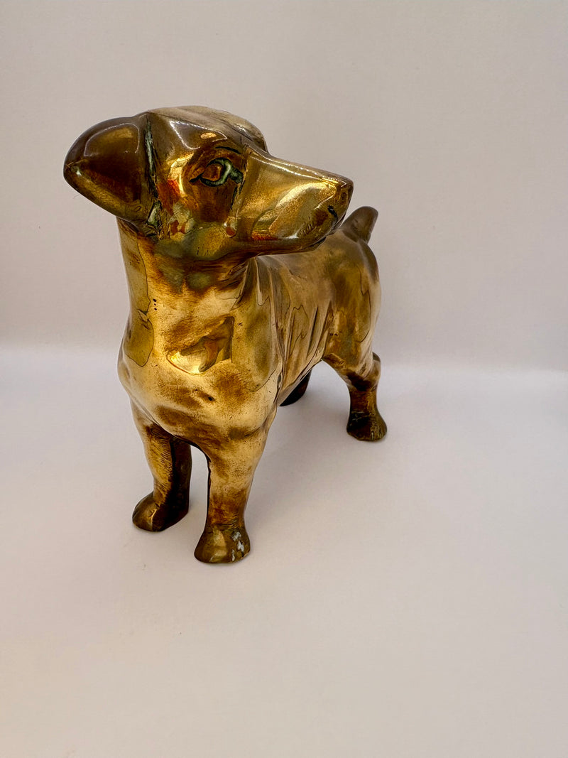 Gold-colored dog figurine on a white background