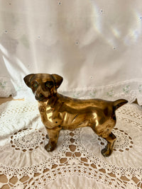 Bronze dog figurine on a lace tablecloth