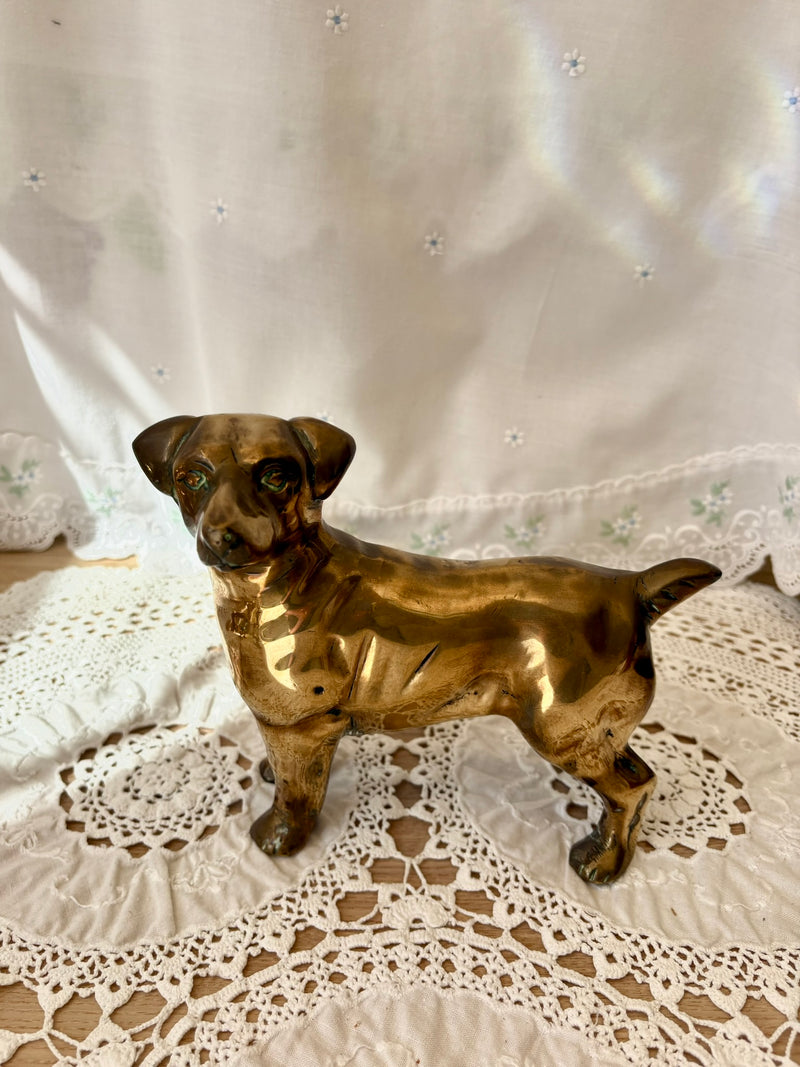 Bronze dog figurine on a lace tablecloth