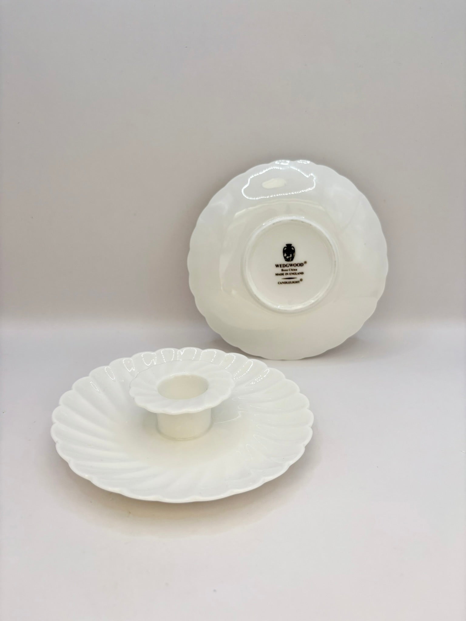 Two white ceramic items on a light gray background