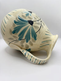 Ceramic vase with floral design on a white background