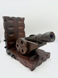 Wooden toy cannon on a white background