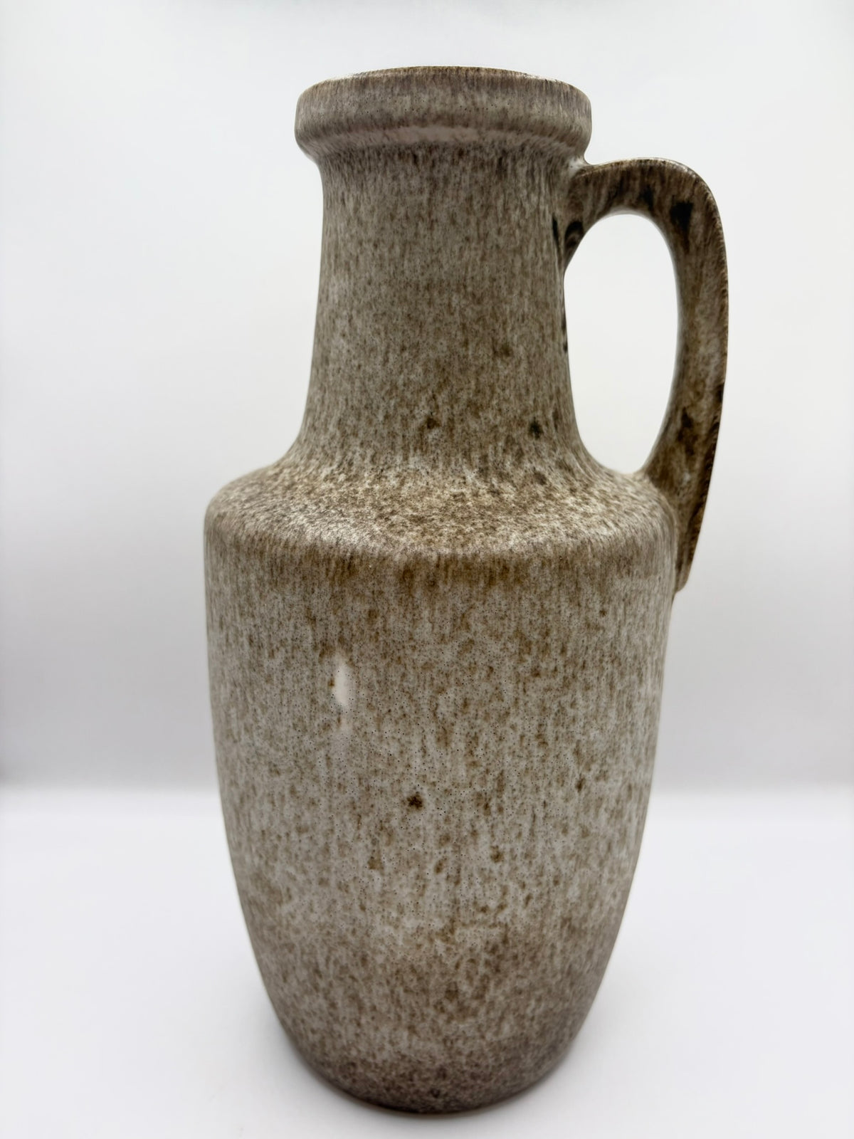 Brown ceramic pitcher on a white background