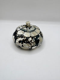 Decorative pot with a black and white pattern on a white background