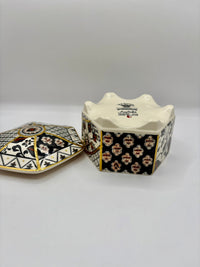 Decorative ceramic container with geometric pattern on a white background