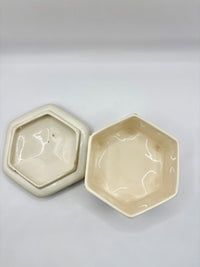 Two hexagonal ceramic bowls on a light gray background