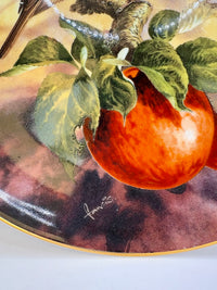 Decorative plate with a persimmon fruit and leaves on a marbled background