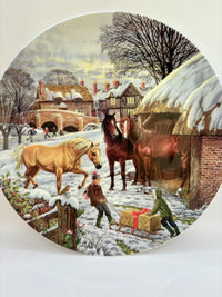 Winter scene with horses and people in a snowy village setting