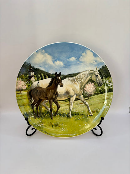 Decorative plate with horses in a field design on a white background