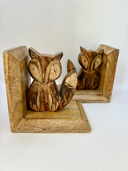Wooden foxes bookends on a white background