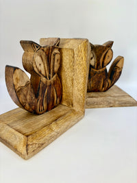 Wooden fox bookends on a white background