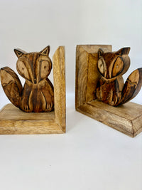 Wooden fox bookends on a white background