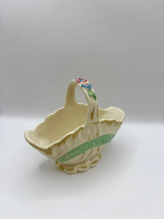 Ceramic basket with floral design on a white background