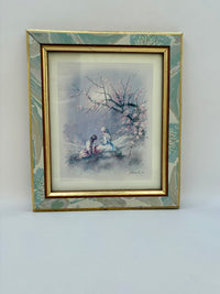Framed artwork of two people under a cherry blossom tree on a white background