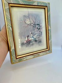 Framed artwork of two people under a cherry blossom tree