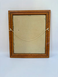 Wooden picture frame with a beige mat on a white background
