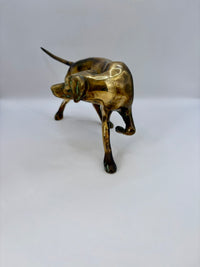 Brass dog figurine on a white background