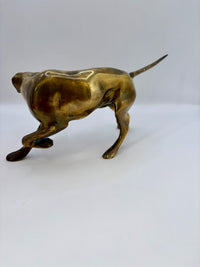 Bronze sculpture of a dog on a white background