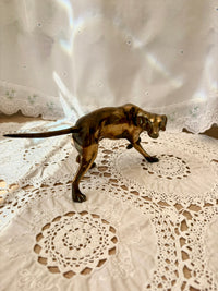 Bronze dog figurine on a lace tablecloth