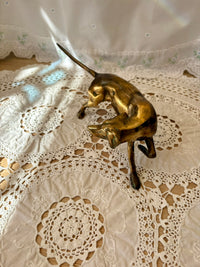 Bronze dog figurine on a lace tablecloth