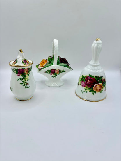 Set of three ceramic items with floral designs on a white background