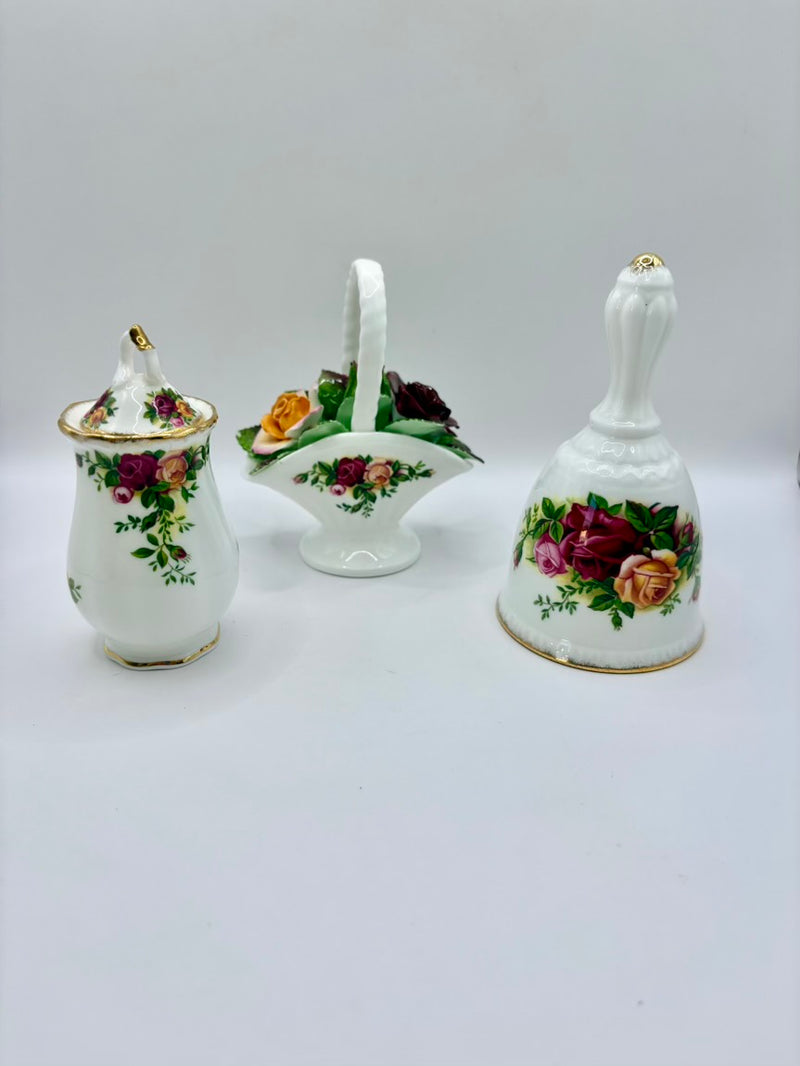 Set of three ceramic items with floral designs on a white background