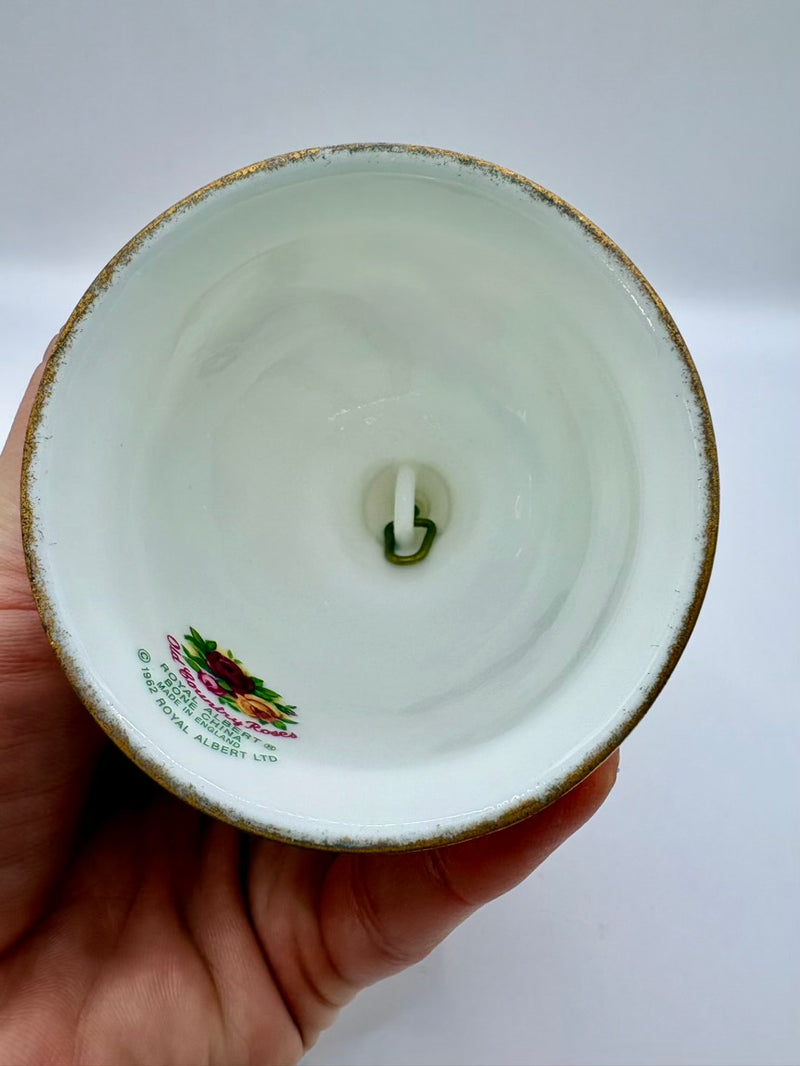 Ceramic bowl held by a hand with a visible brand logo on a white background
