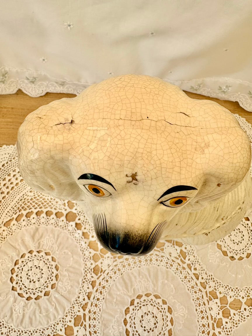 Vintage-style mask with large eyes on a lace doily