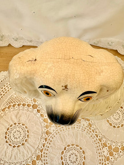 Vintage-style mask with large eyes on a lace doily