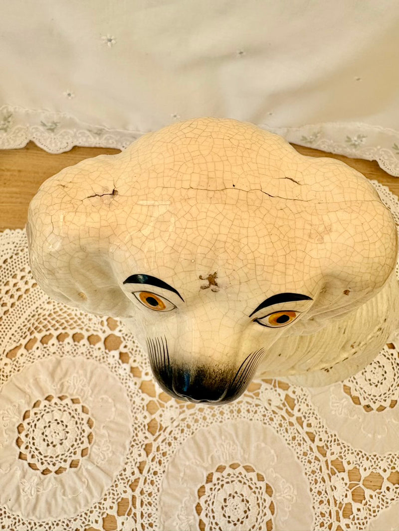 Vintage-style mask with large eyes on a lace doily