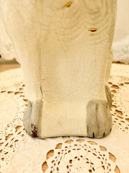 Close-up of a ceramic dog figurine on a doily