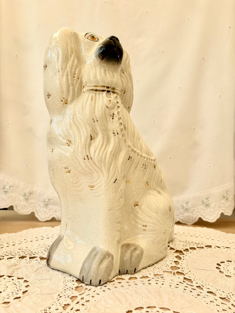 White ceramic dog figurine on a lace tablecloth