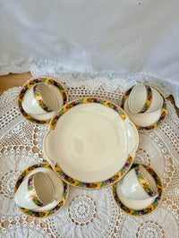 Set of ceramic dishes with decorative rims on a lace tablecloth