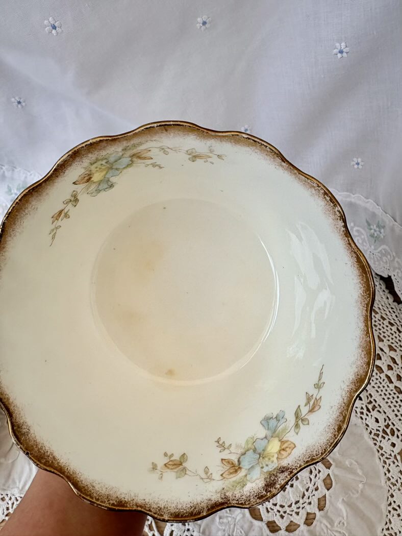 Decorative ceramic cup with floral patterns on a lace tablecloth