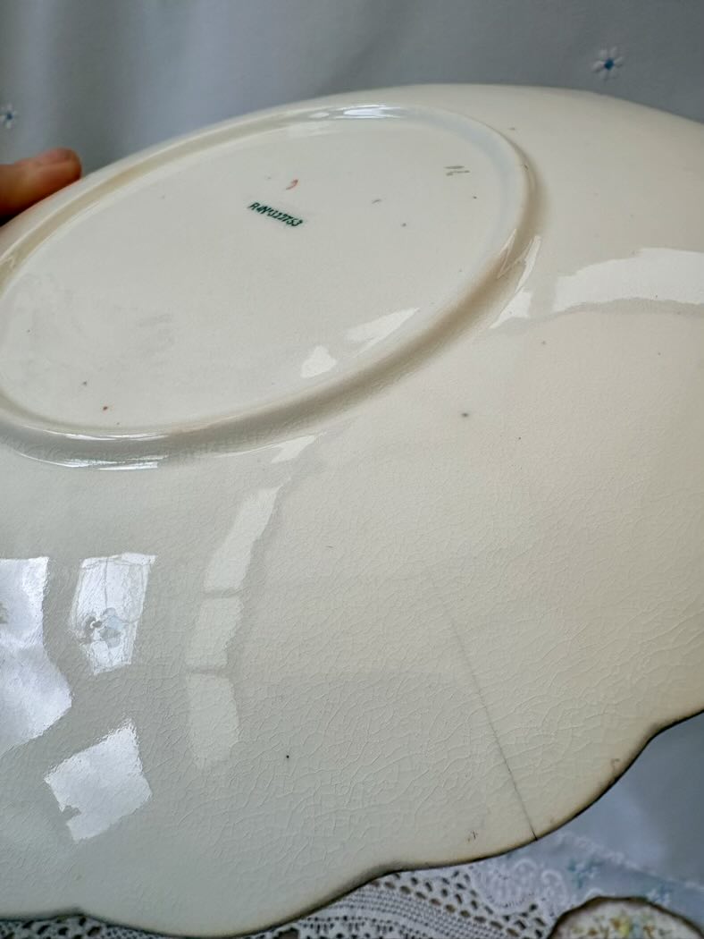 White ceramic plate with visible brand name on a white background