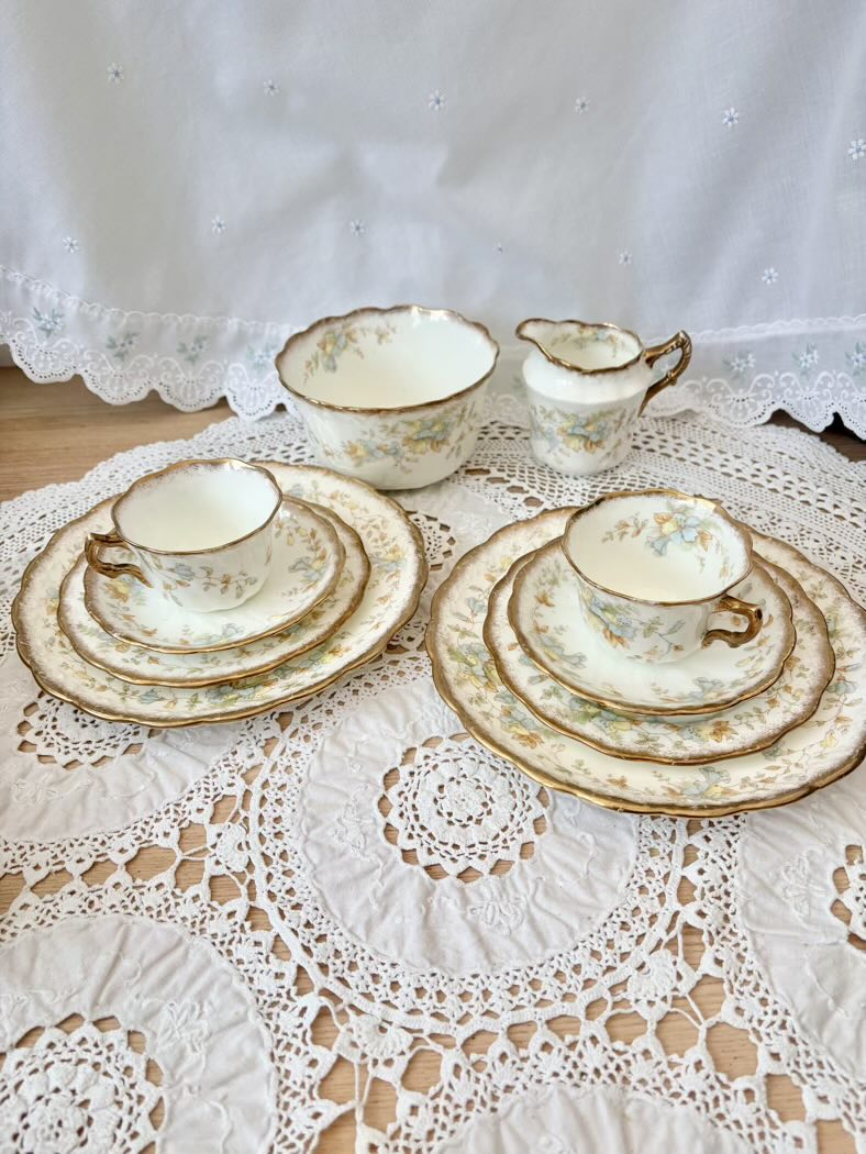 Vintage tea set with floral patterns on a lace tablecloth