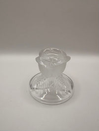 Clear glass object on a gray background