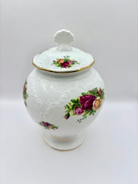 Decorative ceramic jar with floral designs on a white background
