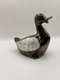 Decorative duck sculpture with mosaic pattern on a white background