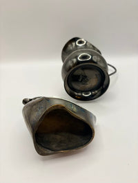 Two metallic objects on a white background