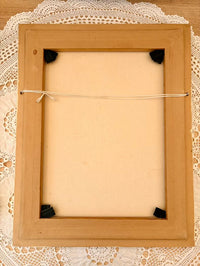 Wooden picture frame on a lace background
