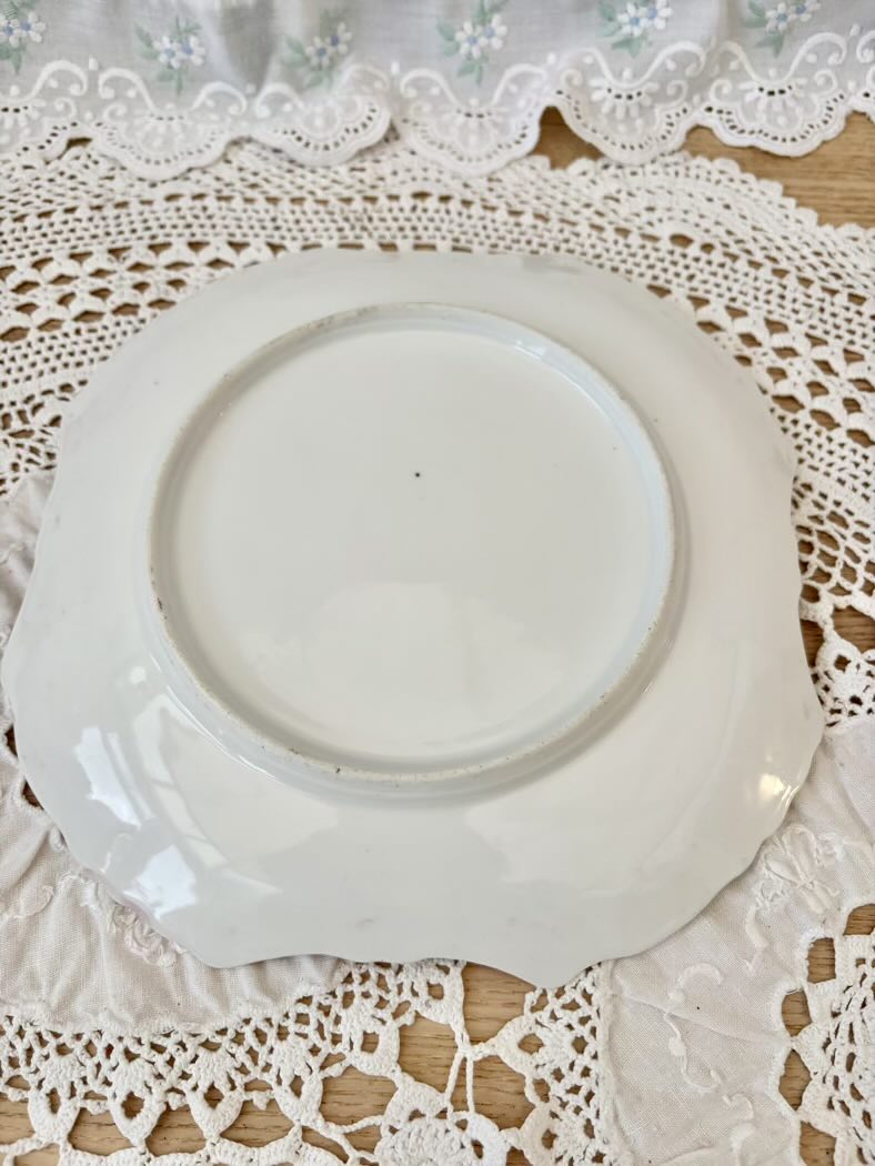 White decorative plate on a lace tablecloth