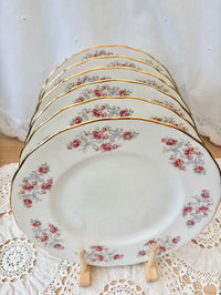 Set of floral-patterned plates stacked on a doily