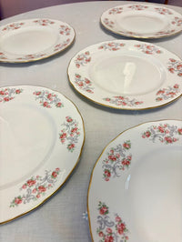 Set of floral-patterned ceramic plates on a light gray surface