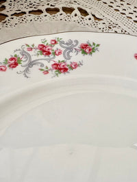 Decorative plate with floral design on a wooden surface
