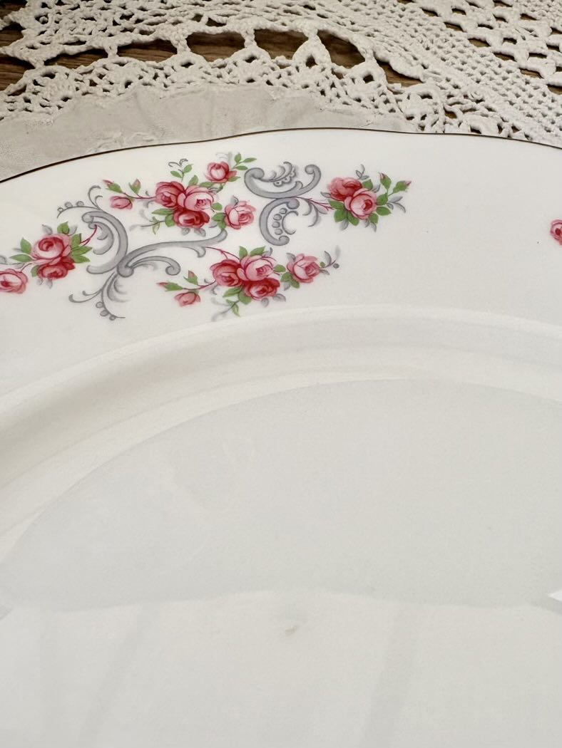 Decorative plate with floral design on a wooden surface