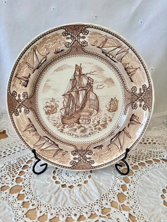 Decorative plate with ship design on a lace tablecloth