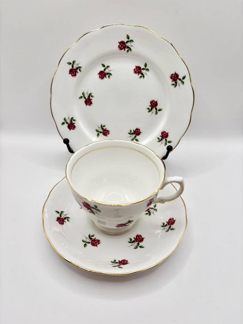 Tea cup, saucer, and lid with floral design on a white background