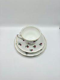 Teacup and saucers with floral design on a white background